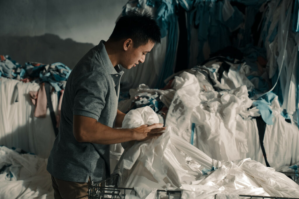 SAYA employee gathering fabric scrap for recycling
