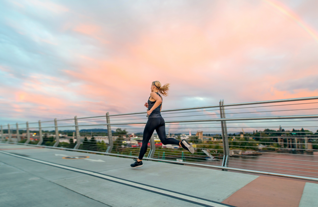 Woman running in athletic apparel made of fiber from recycled plastic bottles